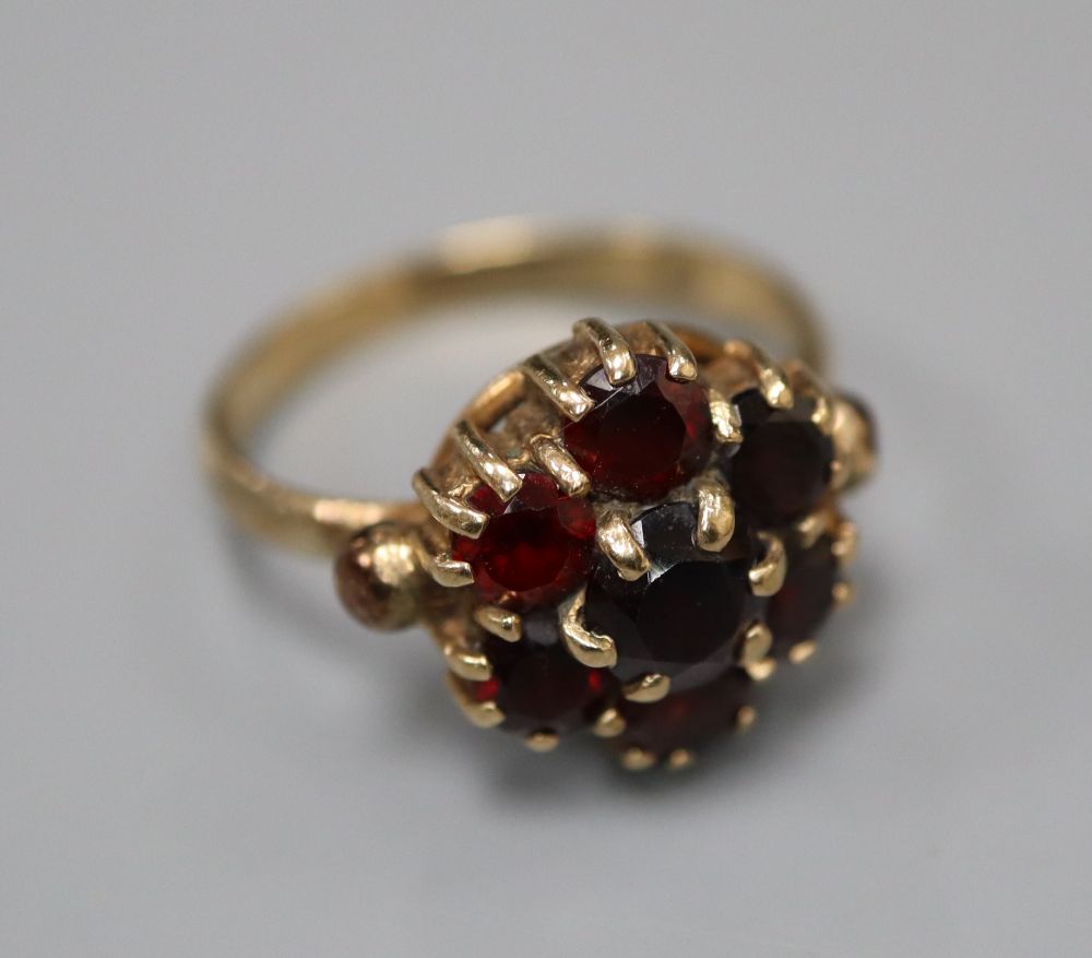 A 1960s 9ct gold and garnet cluster ring, size K/L, gross 3.2 grams.